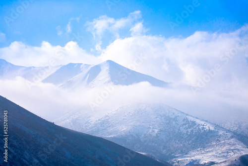 Beautiful nature of rocky mountains and peaks with glaciers. Unusual landscape of nature. Rocks on the background of the sky with clouds. Bad weather cyclone  rainy season  foggy day.