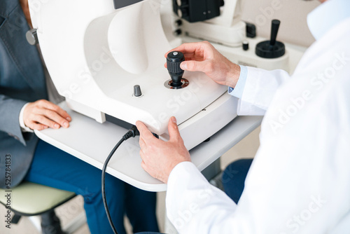 Close-up view of a optometrist checks patient's vision in an optics store or ophthalmology clinic