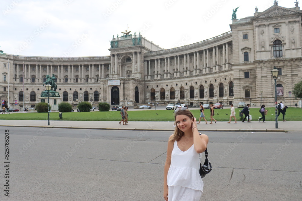 a young European-looking girl poses on Maria Theresa Square in Vienna