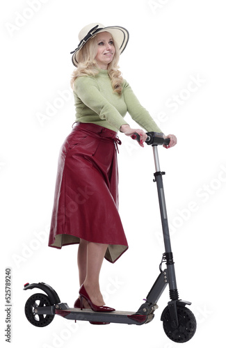 fashionable woman in a summer hat using an electric scooter