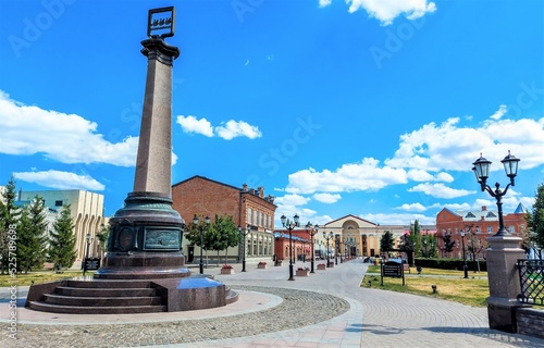 Obelisk in honor of the founding of the city in the public garden in Sterlitamak, the second largest city in the Republic of Bashkortostan, Russia. View of the city. photo