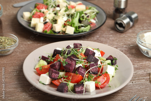 Delicious carrot salad served on wooden table, closeup