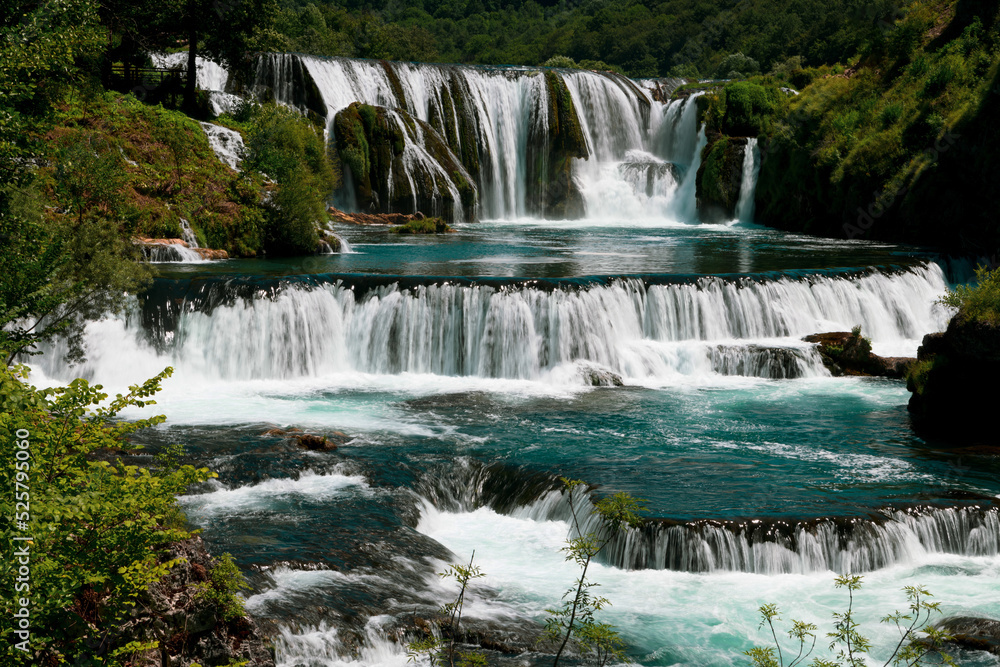 Obraz premium a magnificent waterfall called strbacki buk on the beautifully clean and drinking Una river in Bosnia and Herzegovina in the middle of a forest.