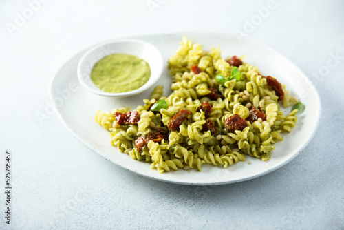 Pasta with pesto sauce and sun dried tomatoes