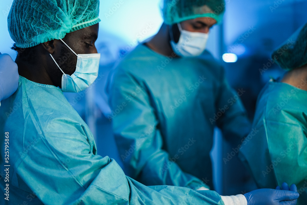 Doctors preparing to work in hospital during coronavirus pandemic outbreak - Focus on african man hat Doctors preparing to work in hospital during coronavirus pandemic outbreak - Focus on african man hat