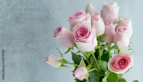 Closeup of pink roses with green small leaves that are a part of a bouquet