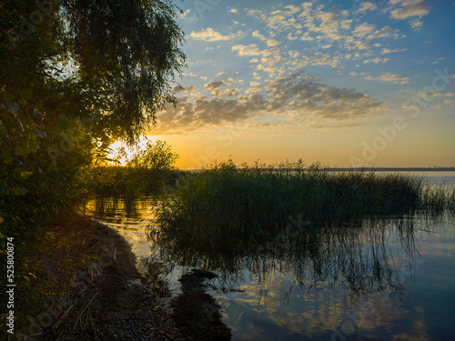 Morning sunrise on a forest lake. Beautiful summer autumn landscape. Calm background