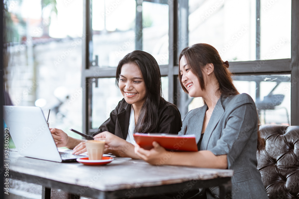 portrait of two businesswoman asian talking while enjoying coffee and working portrait of two businesswoman asian talking while enjoying coffee and working