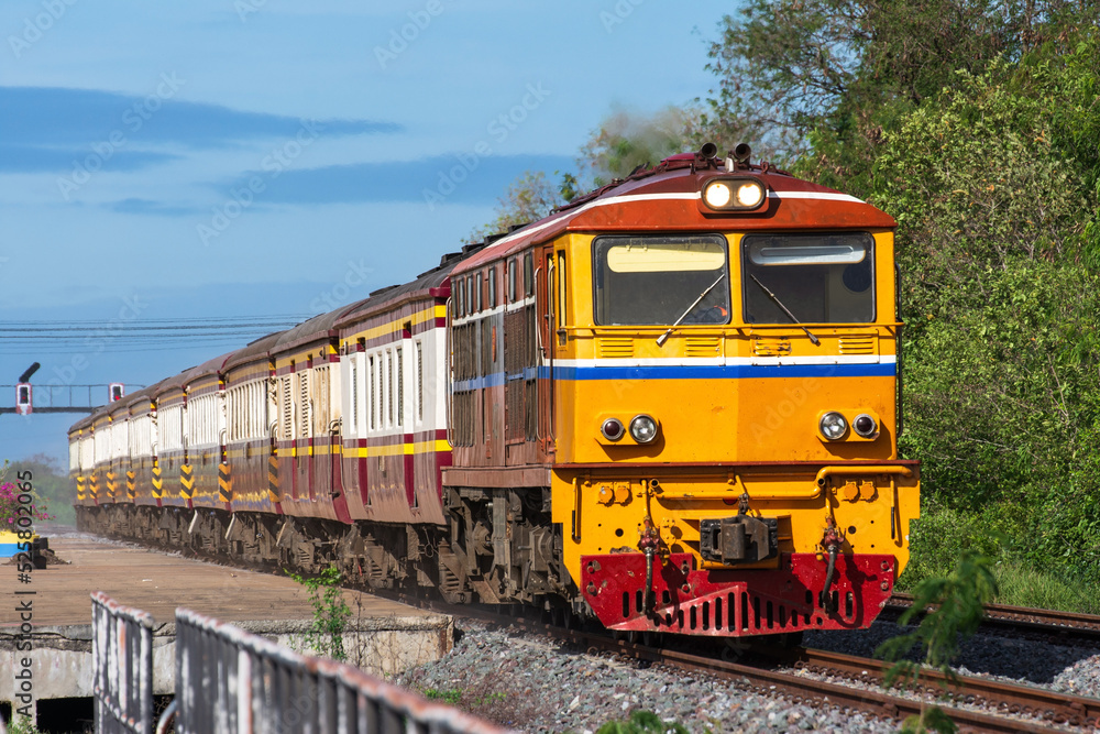 Passenger train by diesel locomotive on the railway in Thailand. Passenger train by diesel locomotive on the railway in Thailand.
