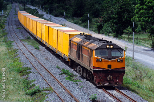 Container-freight train by diesel locomotive on the railway in Thailand