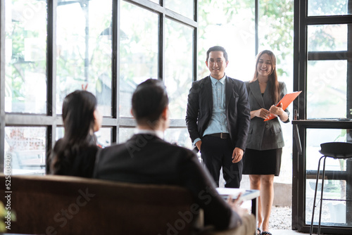 asian young worker while meeting in cafe with partner and assistant © Odua Images