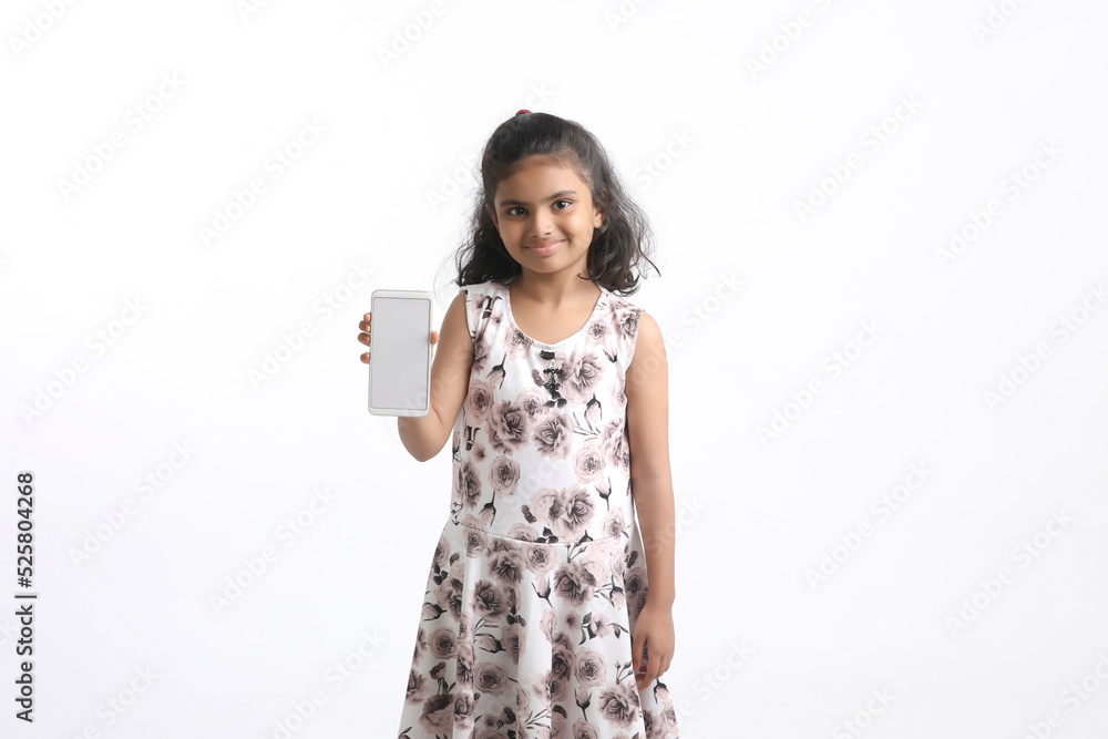 Cute indian little girl showing smartphone on white background. Cute indian little girl showing smartphone on white background.