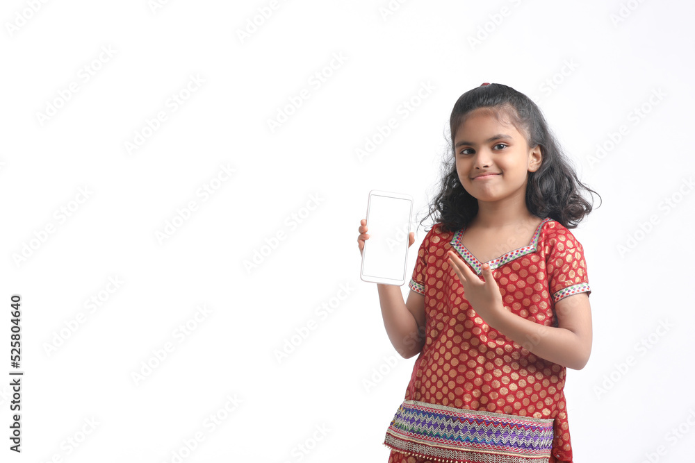 Cute indian little girl showing smartphone on white background. Cute indian little girl showing smartphone on white background.