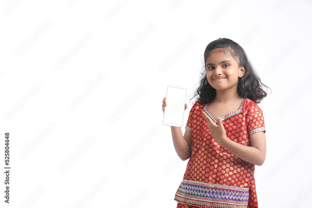 Cute indian little girl showing smartphone on white background. Cute indian little girl showing smartphone on white background.