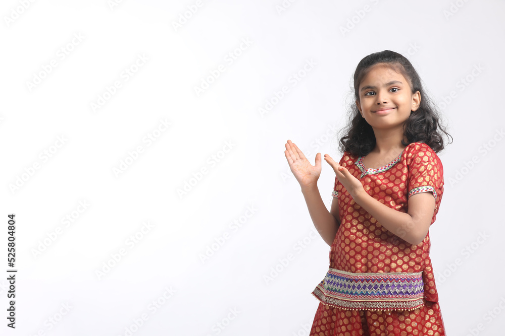 Indian little girl in traditional wear and giving expression on white background. Indian little girl in traditional wear and giving expression on white background.