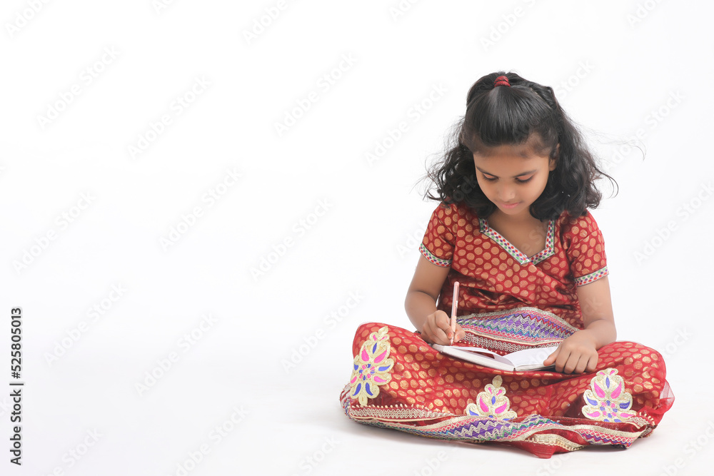 Indian school girl studying on white background. Indian school girl studying on white background.