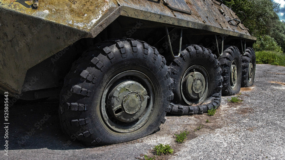 Wheels of armored personnel carriers pierced by bullets during a military battle. Military conflict and weapons. Equipment damage. Wheels of armored personnel carriers pierced by bullets during a military battle. Military conflict and weapons. Equipment damage.