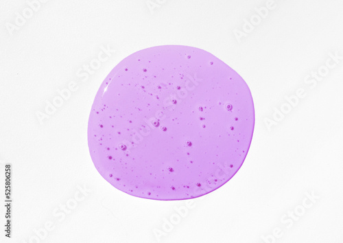 Violet cosmetics gel, serum or peeling drop on white background. Colorful slime with air bubbles in the sunlight. High contrast trendy photo. Health protection, skin care concept