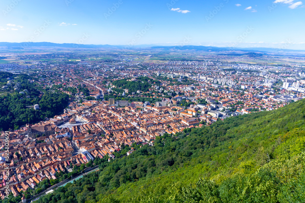 Aerial panorama view over the historical Old Town in the city of Brasov with Tampa mountain in the background. Transylvania, Romania