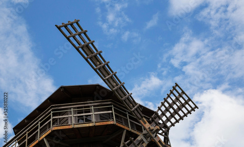 Blades of an old wooden mill against the background of the sky. Old traditions, close-up