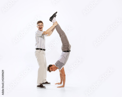 Two cheerfull dudes, young men having fun isolated on white background. Vintage, retro style concept