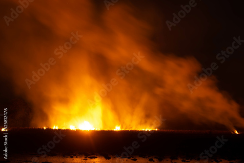 The flames were burning violently in the night fields.