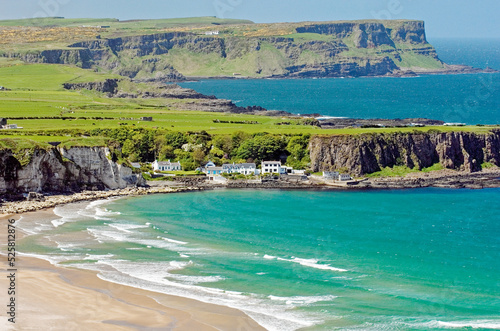 White Park Bay on the Giants Causeway Coast of County Antrim, Ireland. Looking to Portbraddon village and the Causeway headlands photo