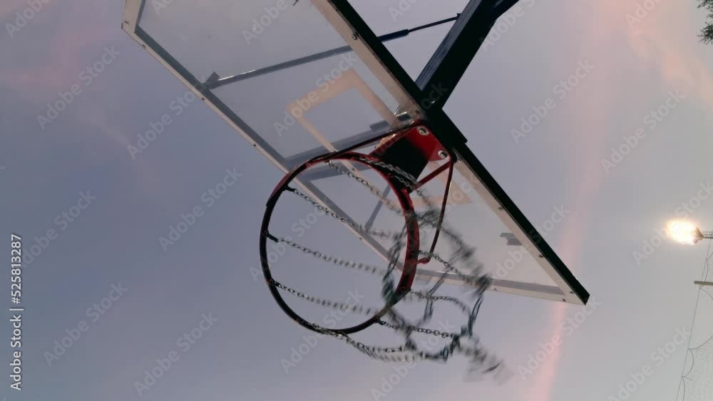 Street basketball ball falling into the hoop. Vertical video. Street basketball ball falling into the hoop. Vertical video.