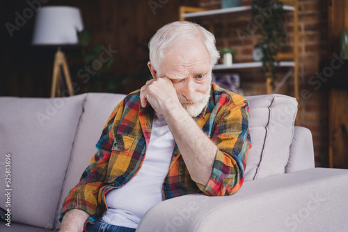 Vászonkép Photo of sad depressed man pensioner wear checkered shirt crying sitting sofa in
