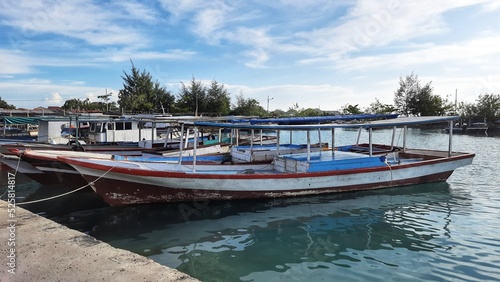 Fishing boat leaning on the dock with clear sky