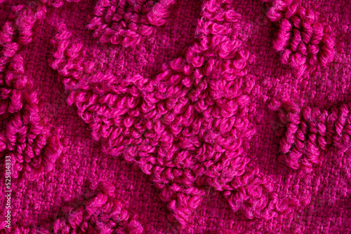texture of burgundy terry towel with a pattern, close-up. Background, vinous