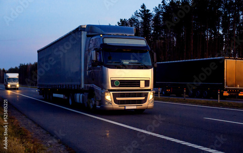 A beautiful truck with a trailer against the backdrop of an evening sunset before night. The concept of work and rest regime for truck drivers. Fine for breaching rules