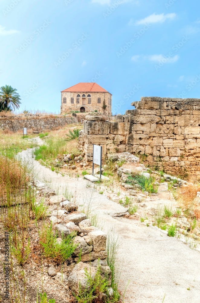 An abandoned traditional Lebanese house in Byblos, Lebanon. View of the colonial architecture with terracotta tile roof and limestone facade. An abandoned traditional Lebanese house in Byblos, Lebanon. View of the colonial architecture with terracotta tile roof and limestone facade.