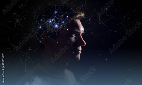 The profile of a thoughtful young man, the concept of brain activity of self-knowledge and personality development. Thinking like stars, the cosmos inside human, background night sky photo