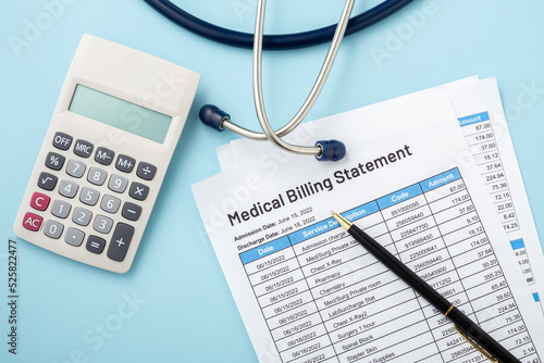 Medical billing statement with calculator and pen, healthcare payment