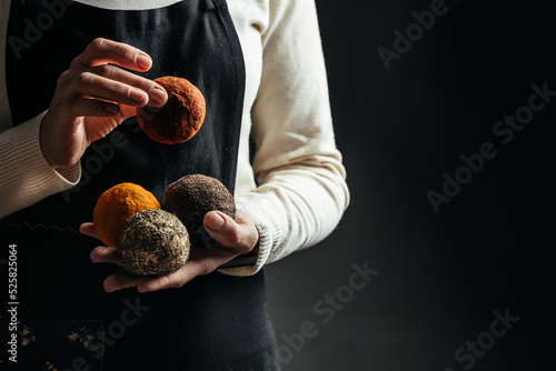 Swiss belper knolle cheese. Woman hands hold basket with belper cheese on a dark background photo