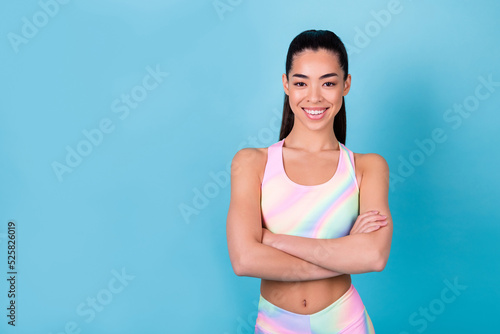 Photo of positive sportive lady pilates coach cross arms wear multicolor print sport suit isolated blue color background