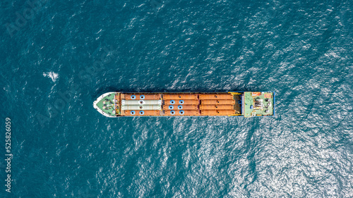 Cargo ship carries industrial metal pipes at sea. © MagioreStockStudio