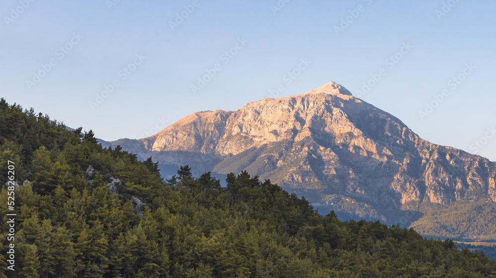 Taurus mountains and forest Landscape on sunset light, blue sky background in Antalya Turkey.