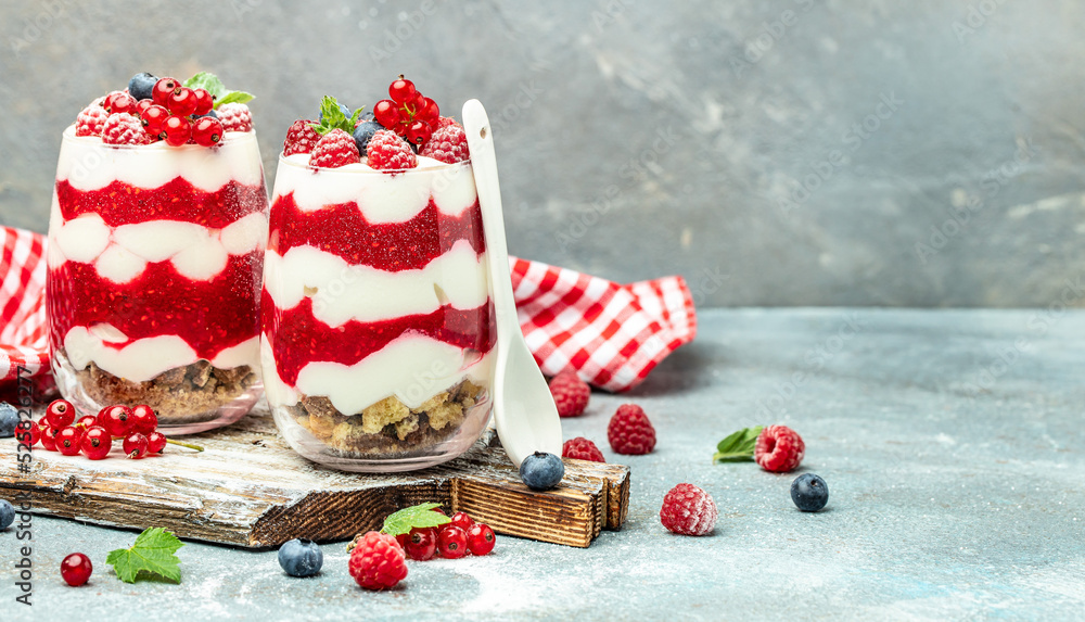 Cranachan raspberry dessert in jar on a lighr background. Long banner format Cranachan raspberry dessert in jar on a lighr background. Long banner format