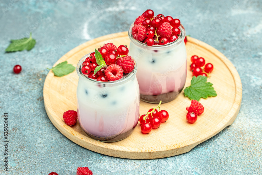 Raspberry dessert cheesecake, trifle, mouse in a glass. Raspberry Greek yogurt granola parfait on a light background. Restaurant menu, dieting, cookbook recipe Raspberry dessert cheesecake, trifle, mouse in a glass. Raspberry Greek yogurt granola parfait on a light background. Restaurant menu, dieting, cookbook recipe