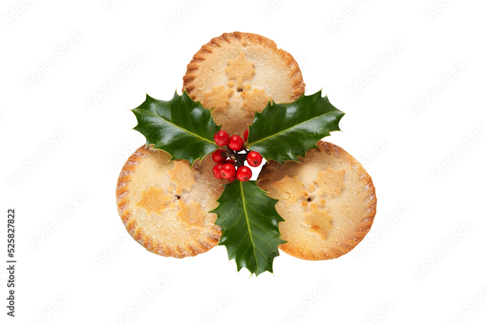 Three Christmas mince pies with holly isolated against a flat background.