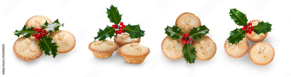 A collection of Christmas mince pies with holly isolated against a flat background.