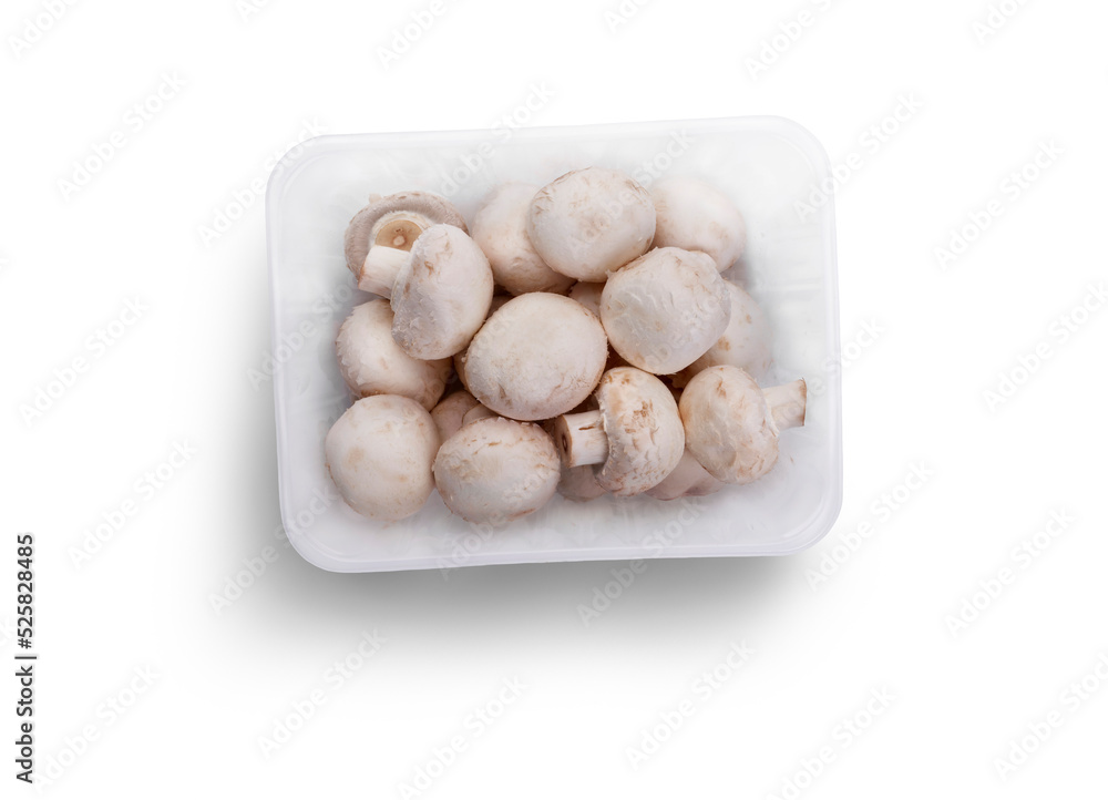 A top view of a punnet of Champignon, white button mushrooms isolated against a flat background. A top view of a punnet of Champignon, white button mushrooms isolated against a flat background.