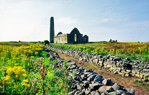 Scattery Island, County Clare, Ireland. Celtic Christian Saint Senan's Cathedral and round tower. Temple Senan in right distance photo