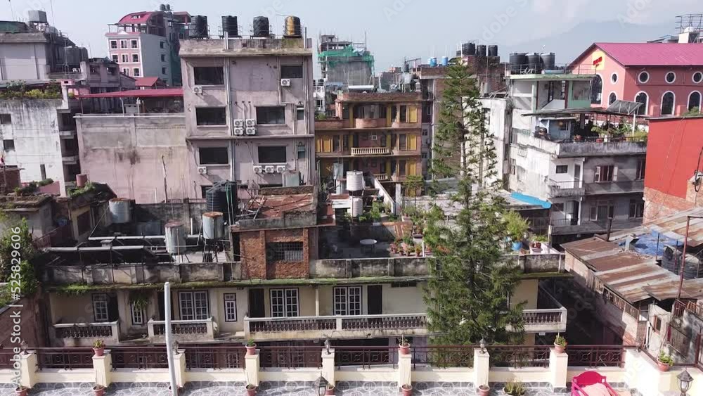 Drone flying low over tall old buildings in Katmandu, Nepal. Overpopulation concept. Drone flying low over tall old buildings in Katmandu, Nepal. Overpopulation concept.
