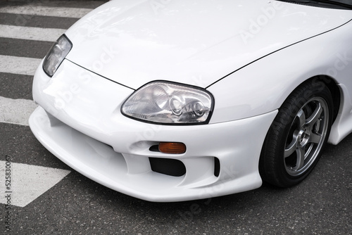 front headlight of white sport car close-up © Irina