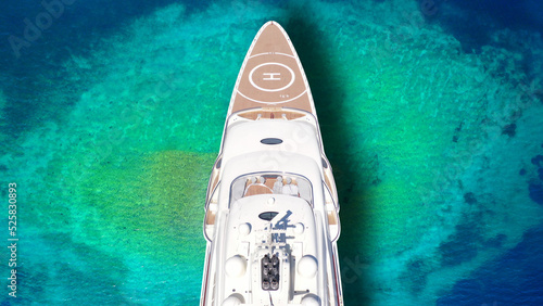 Aerial drone top down ultra wide photo of luxury yacht anchored in tropical exotic island bay with crystal clear turquoise sea © aerial-drone