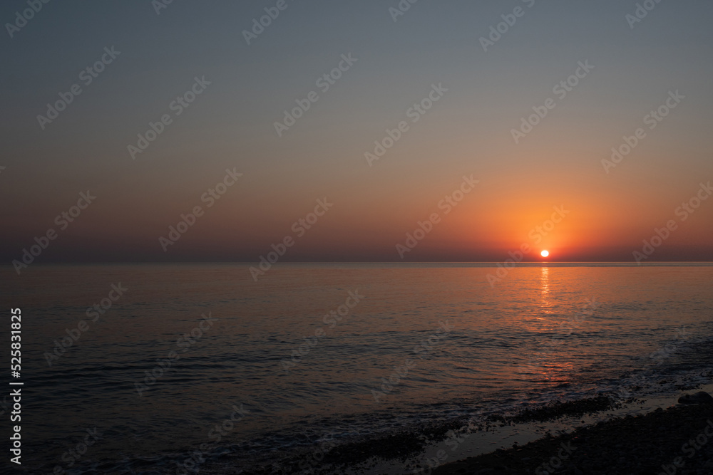 Pink sunset in the sea, gentle romantic natural background. Unity with nature