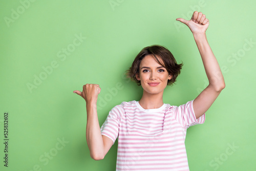Photo of funny young lady index promo wear white striped t-shirt isolated on green color background